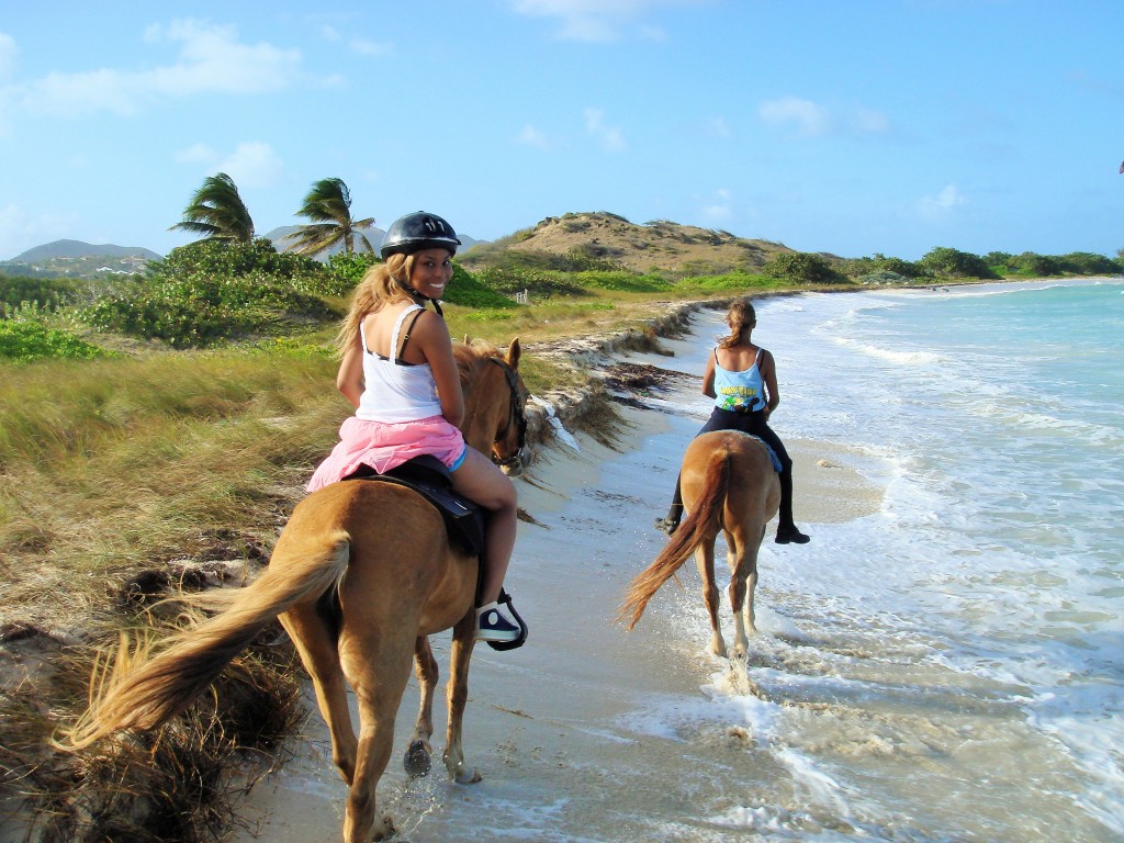 Africah horseback riding on the beach.